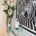 White Vanda Orchids and Driftwood Inside a Large Conical Glass Cylinder
